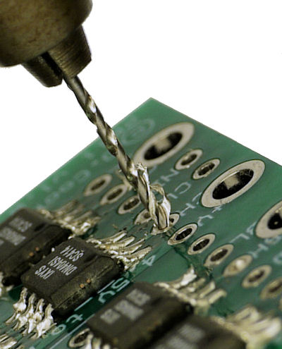 Drill removing excess solder from hole